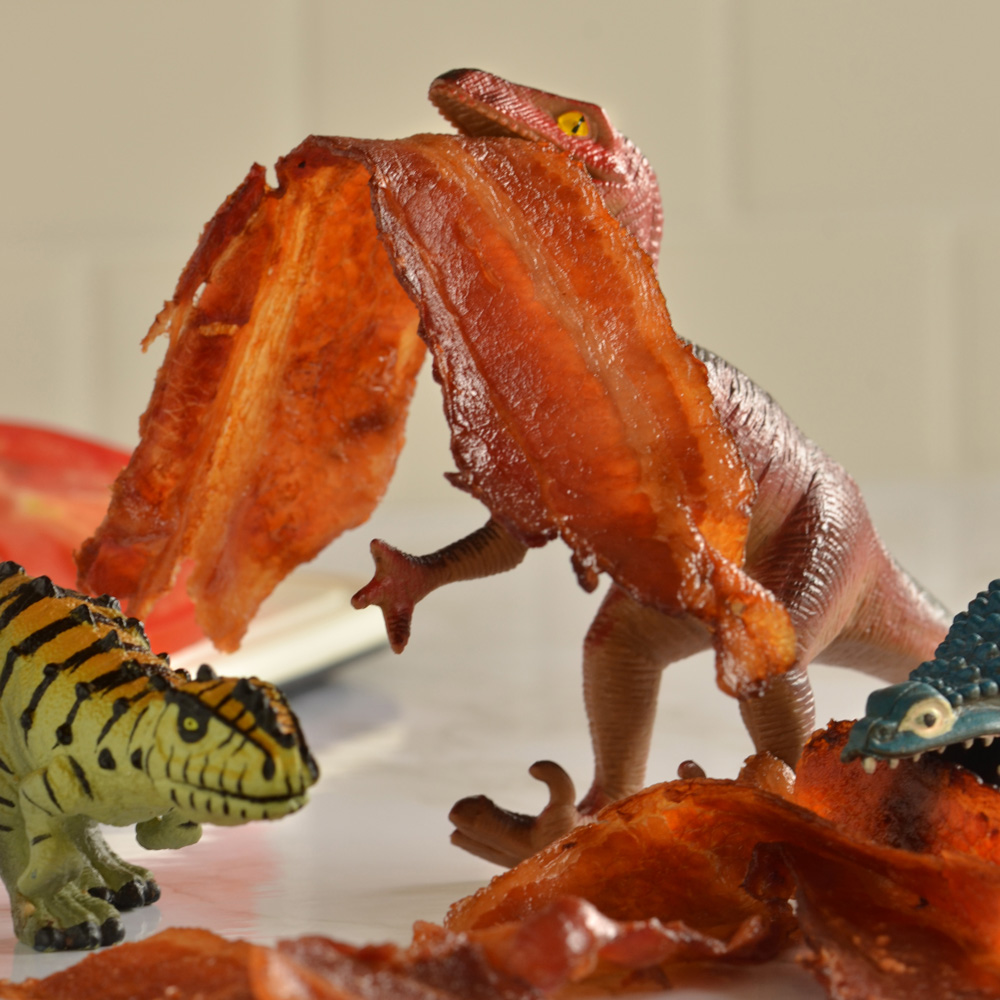 Unknown dinosaur, Oswald, and Alex eating bacon