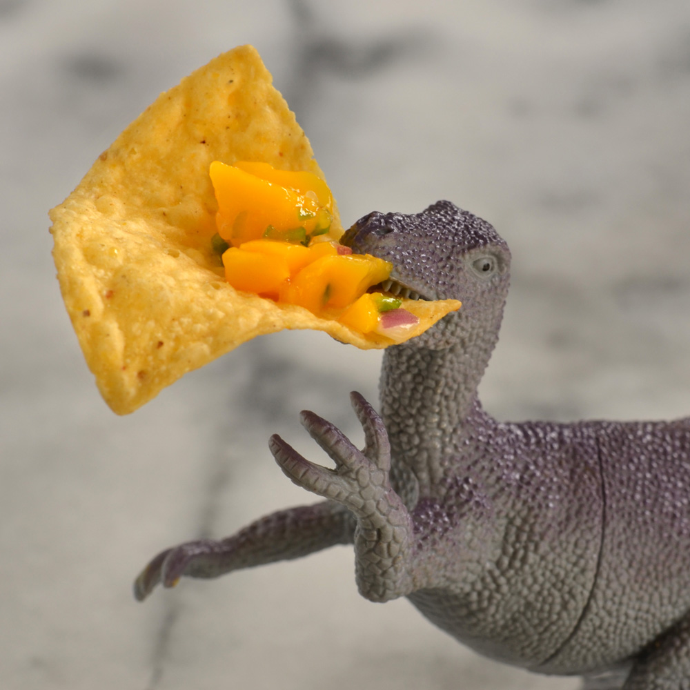 Jamal eating chip with mango salsa
