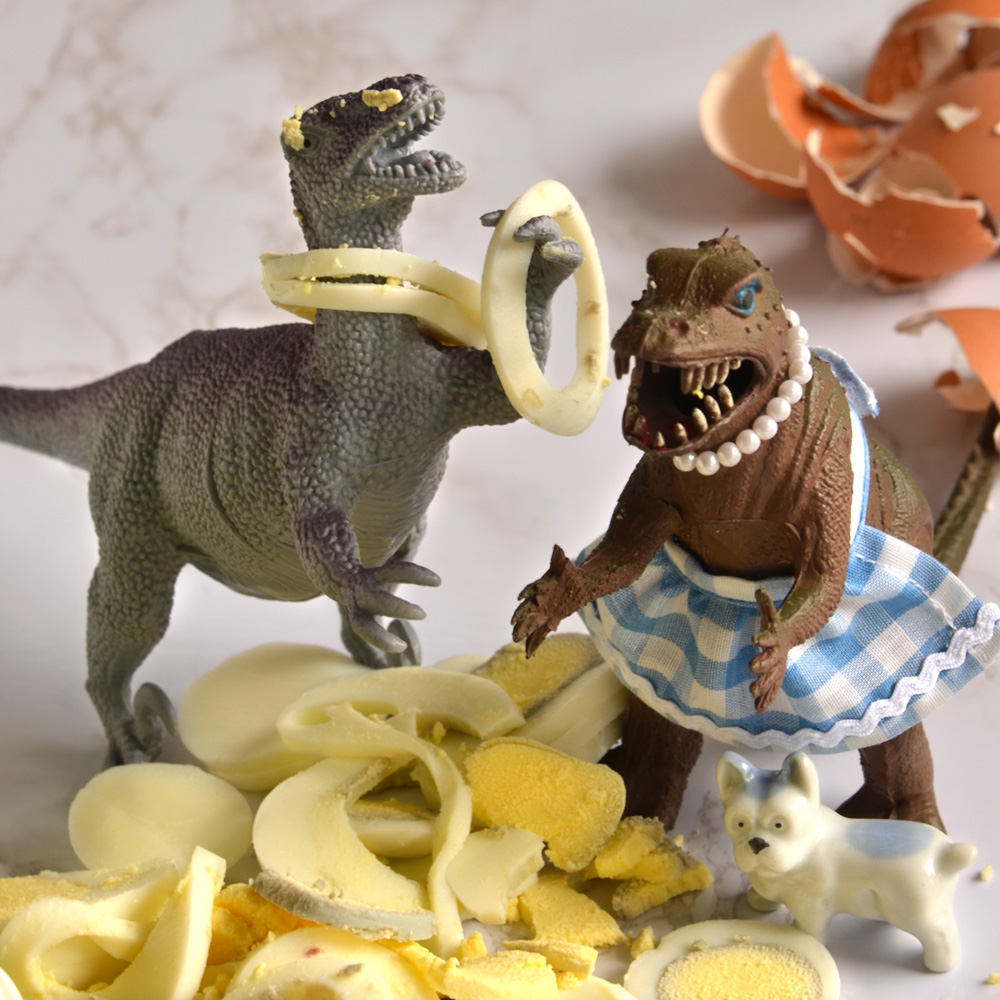 Jamal, Vickie and Pickles stand in a pile of sliced hard boiled eggs