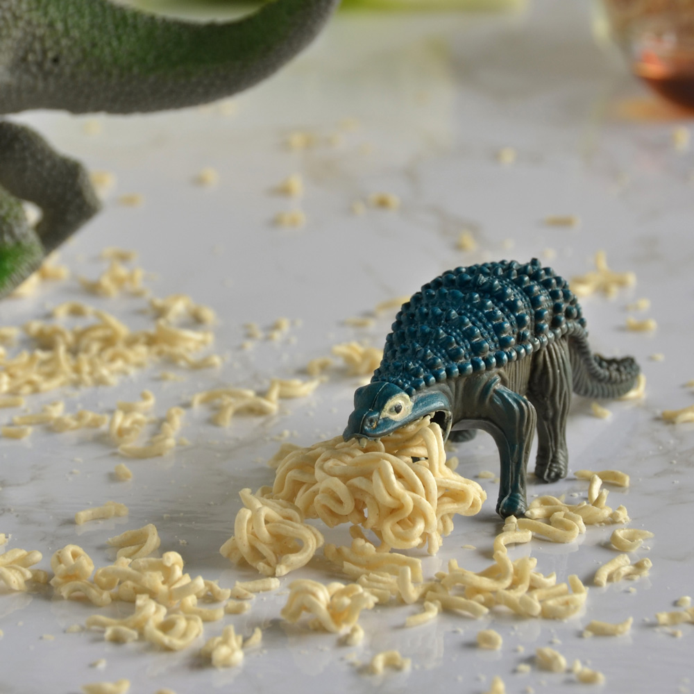 Alex munches on some dry ramen noodles