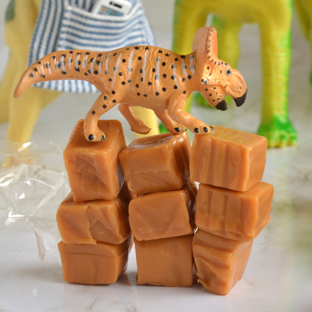 Spike delicately walks on stacked caramel candy