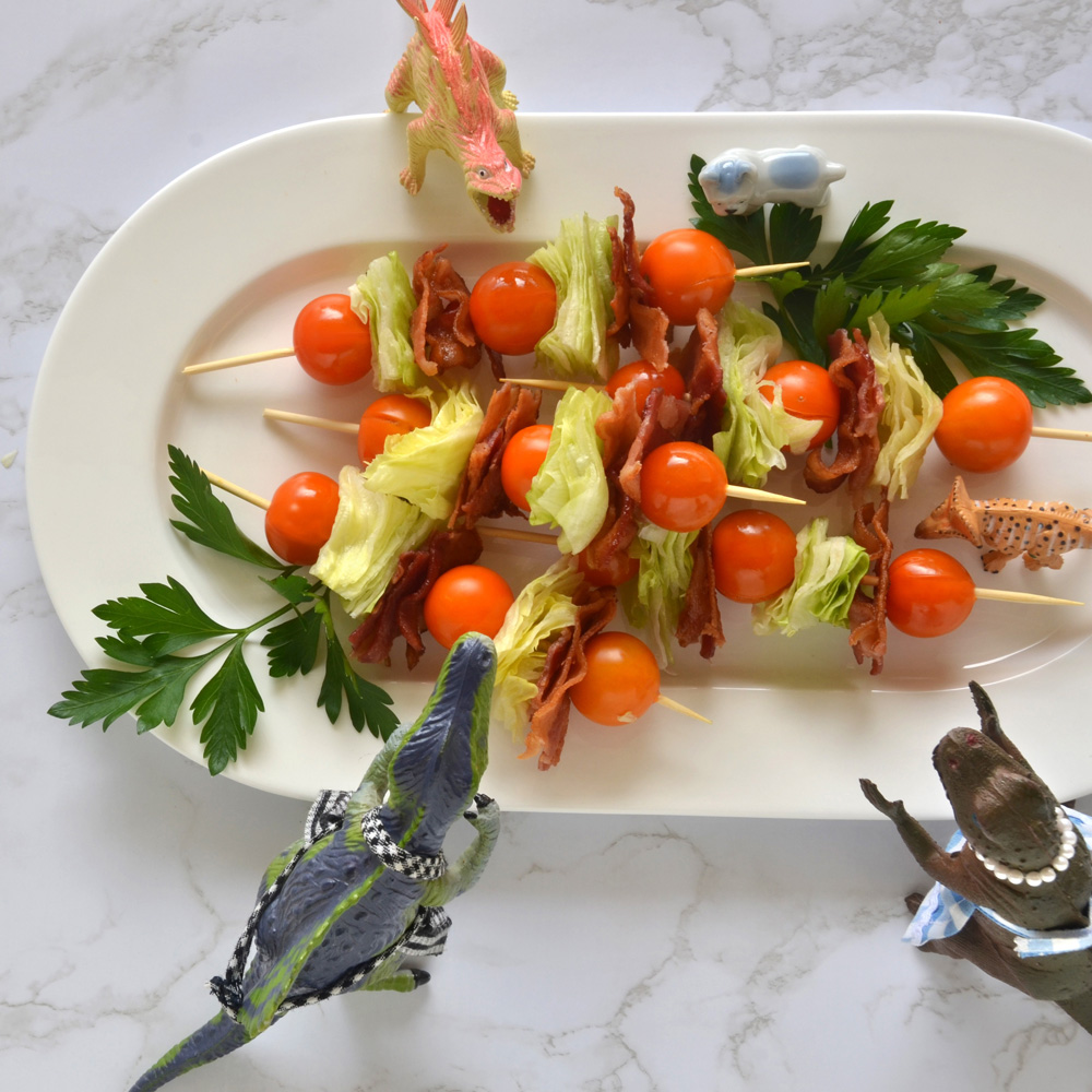 Spino, Vickie, Spike, Pickles and Ping surround a white platter of BLT kabobs