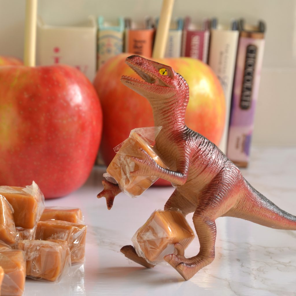 Mystery Dude wrangles some cellophane wrapped candy carmels for caramel apples.