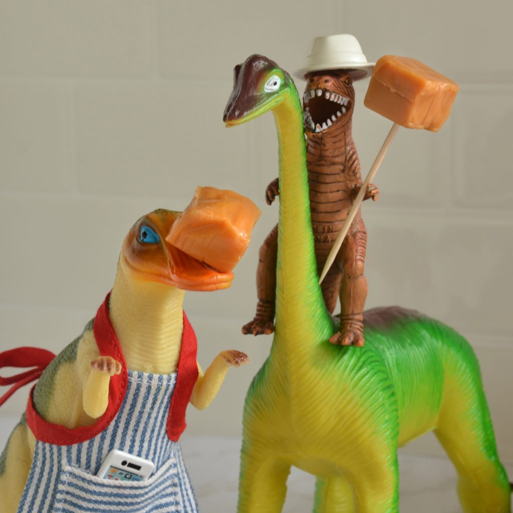 TJ and Dean hold caramels for the caramel apples