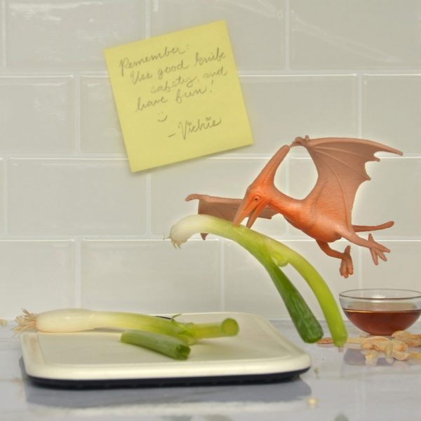 Art flies in with a green onion for the ramen coleslaw